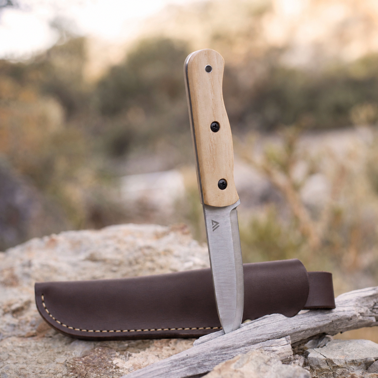 Knife with wooden handle and leather sheath on a rock with a natural background