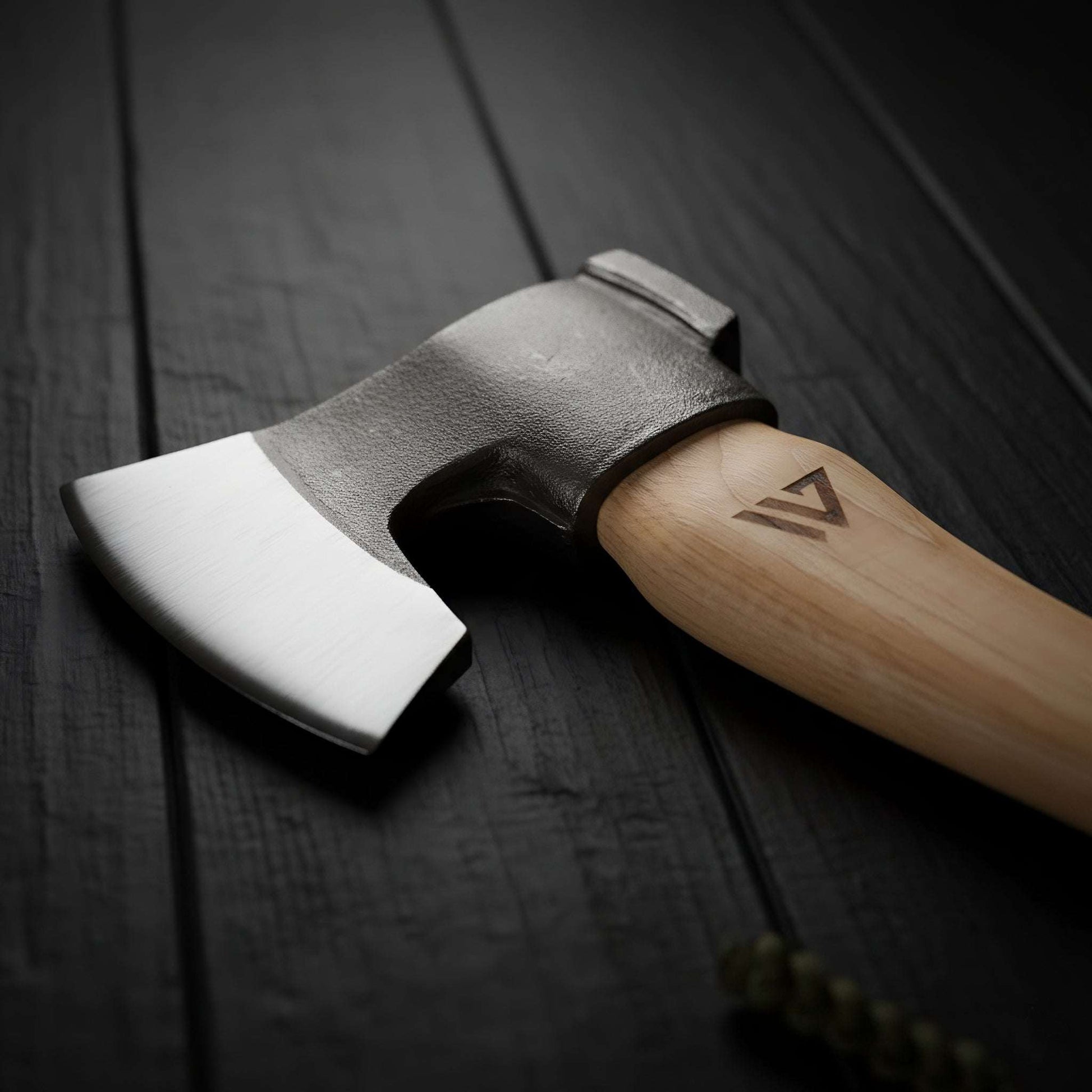 Axes with wooden handles on a dark wooden surface